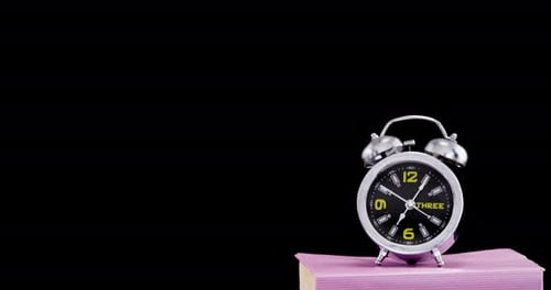 Vintage Alarm Clock on Stack of Hardcover Books