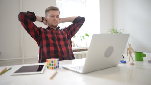 Man Typing on Laptop at Bright Desk