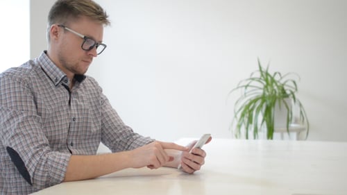 Young Adult Using Smartphone Indoors
