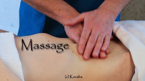 Woman Receiving Abdominal Massage From Therapist