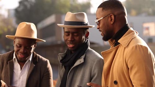 Three Stylish Men Using Smartphones in the City