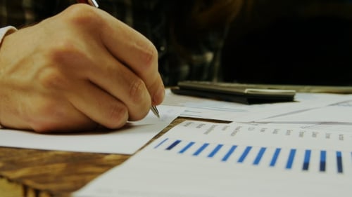 Writing on Paper in Workplace Setting