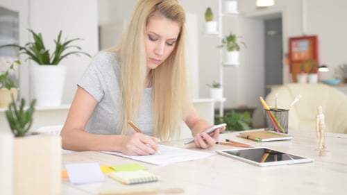 Designer Working in Office, Smartphone and Documents