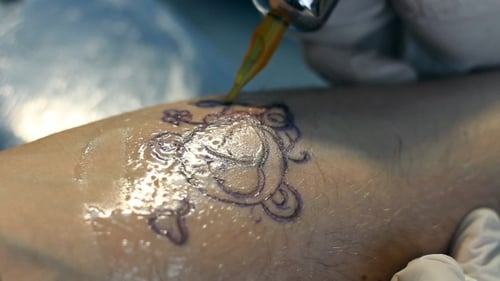 Tattoo Artist Creating Intricate Skin Art