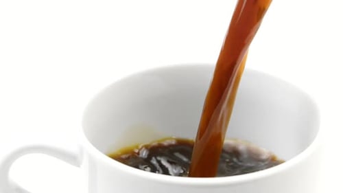 Dark Coffee Being Poured into White Mug