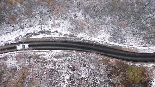 Luftaufnahme von oben auf Autofahren auf verschneiter Landstraße - Luftvideo von Win