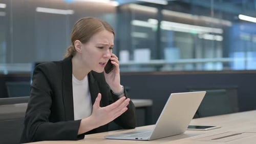 Frustrated Woman On Phone In Office Setting