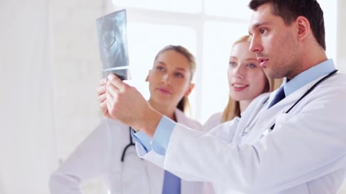 Two Doctors Discussing X-ray Image At Hospital 59