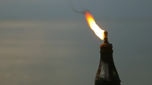 Flames Erupting From Industrial Chimney During Sunrise