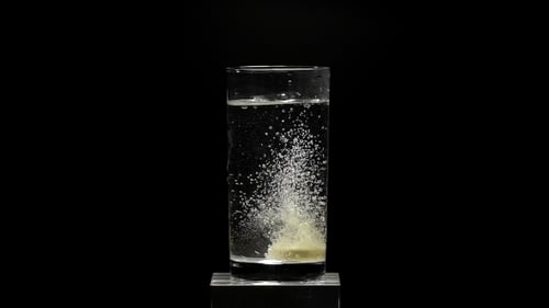 Effervescent Tablet Dissolving in Glass of Water