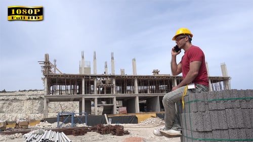 Construction Worker Talking on Cell Phone at Site