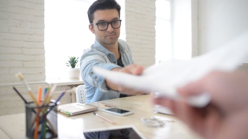 Designer Giving Completed Assignment