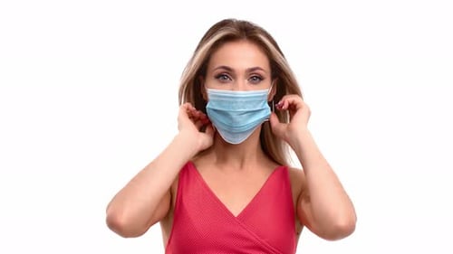 Portrait of Woman Putting on Face Medical Protective Mask