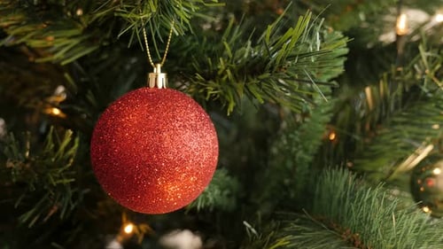 Hanged red Christmas ornament close-up 4K 2160p 30fps UltraHD footage - Bauble with sequins on the