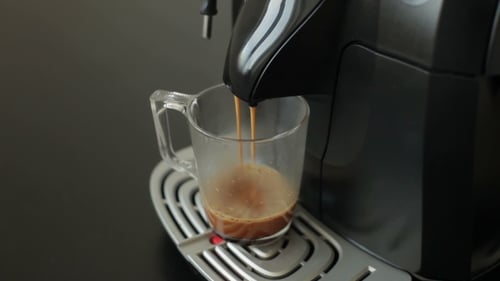 Espresso Machine Dispensing Coffee into Glass Mug