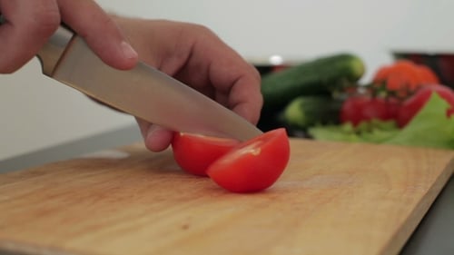 Cutting a Fresh Tomato with Sharp Knife