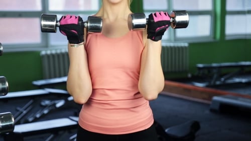 Woman With Dumbbells In a Gym