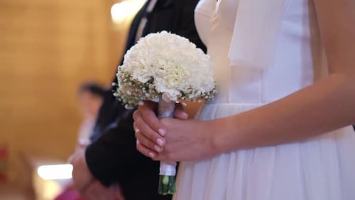 Bride Holding Bouquet at Wedding Ceremony