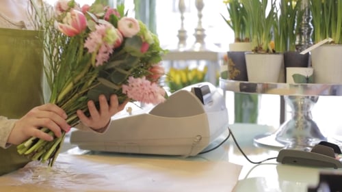 Florist Wrapping Flowers In Paper At Flower Shop 14