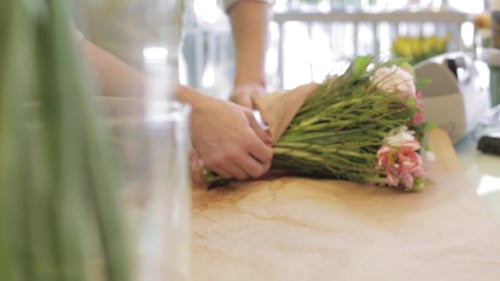 Florist Wrapping Flowers In Paper At Flower Shop 25