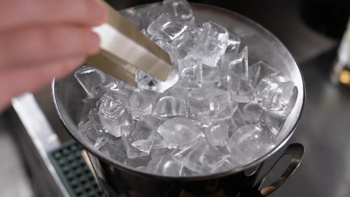 Adding Ice to Silver Bucket with Scoop