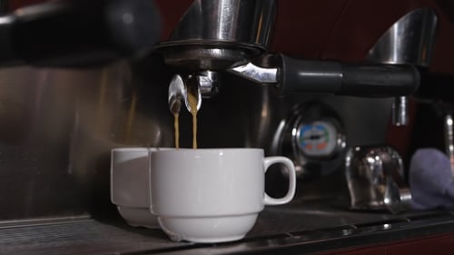 Espresso Machine Pouring Coffee into Mugs
