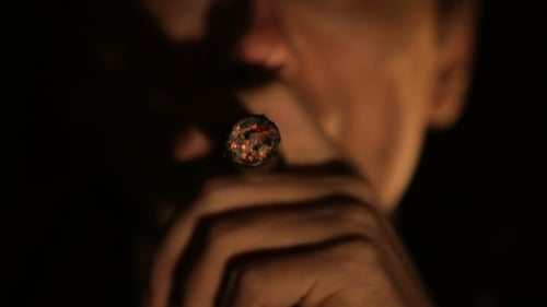 Close Up of Man Smoking a Lit Cigar