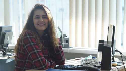 Beautiful Girl Works In The Office And Smiling At Camera