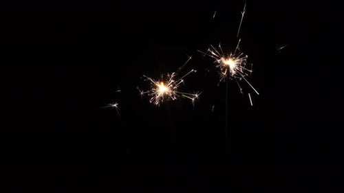 Sparkling Sparklers Glowing Against a Black Background