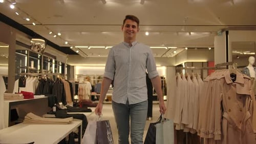 Man Carrying Shopping Bags in Upscale Clothing Store