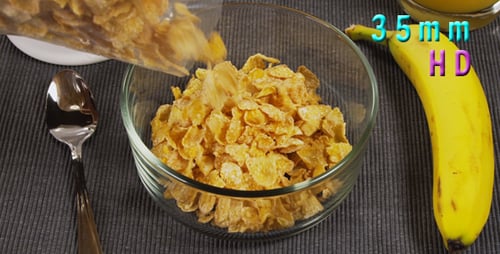 Pouring Crispy Cornflakes in Bowl for Breakfast