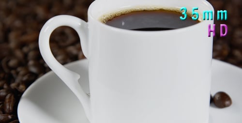 Black Coffee in Mug Surrounded by Coffee Beans