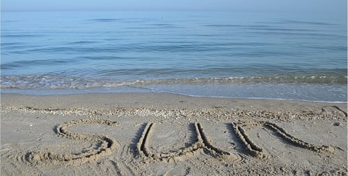 Seascape with Word Sun Written on Sandy Beach