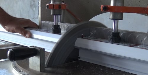 Man Cutting Trim with Power Saw in Workshop