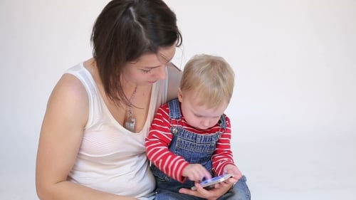 Woman and Child Using a Smartphone Together