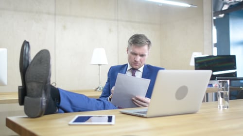 Relax Businessman Working in Office, Legs on Table