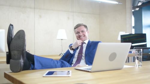 Man Relaxing with Feet Up in Modern Office