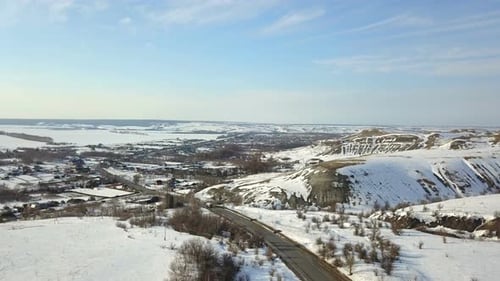 A Truck And A Car On The Winter Road Near Village