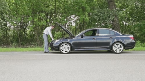 Young Handsome Man Repairing Car At The Road