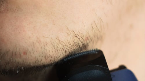 Man Shave Chin With Electric Shaver In .