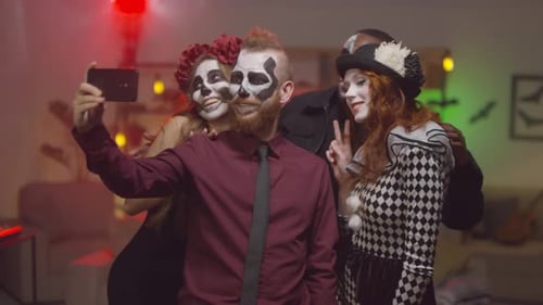 Friends in Halloween Costumes Take Selfie