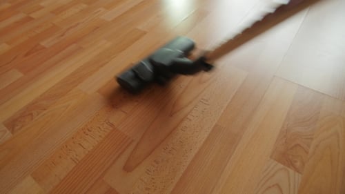 Vacuum Cleaner Used on Wooden Floor