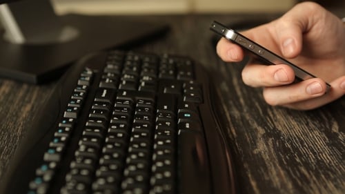 Mobile Phone At Wooden Desk