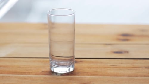 Glass Being Filled with Clear Liquid, Water