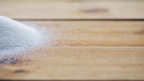 White Sugar Pouring Into Heap On Wooden Table 52