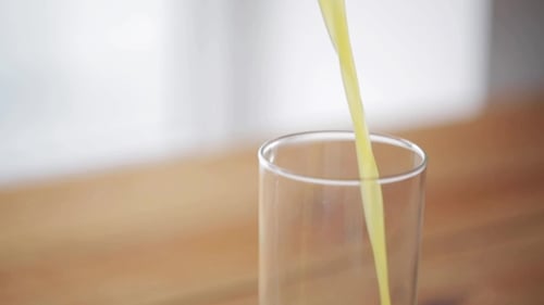 Fresh Orange Juice Being Poured Into Glass