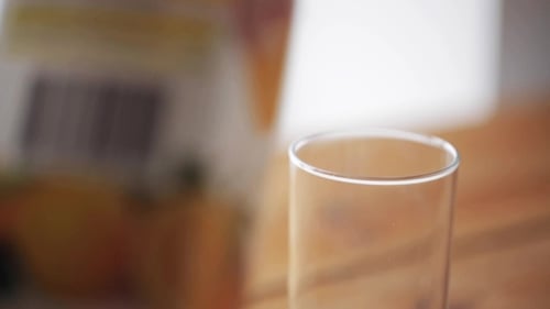Fresh Orange Juice Being Poured into Glass
