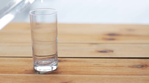 Glass of Water Being Poured on Table