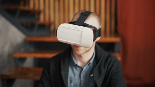 Man Experiencing Virtual Reality with Headset Indoors
