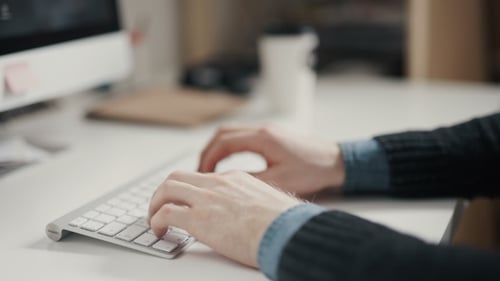 Close Up Hands Typing on a Keyboard